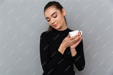 Free Photo Smiling Shy Brunette Woman In Black Clothes Holding Cup Of