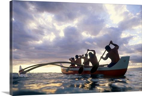 Hawaii Men On Outrigger Canoe Paddle Into Sunset Under Dramatic Clouds