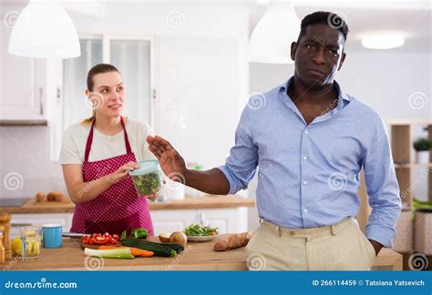 Dissatisfied Husband Quarreling With His Wife In The Kitchen During