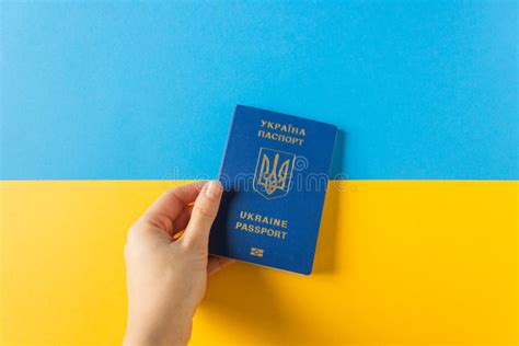 Woman S Hand Hold Ukraine Biometric Passport On The National Flag Of