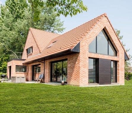 A Brick House Sitting On Top Of A Lush Green Field