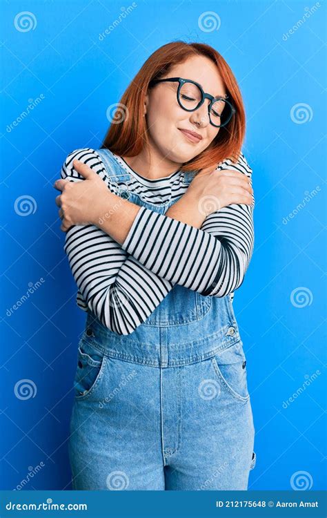 Beautiful Redhead Woman Wearing Casual Clothes And Glasses Hugging