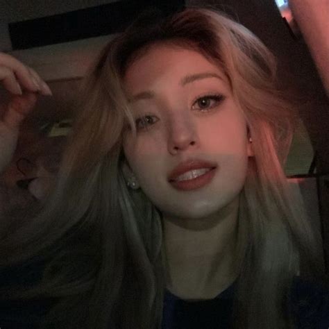 A Woman With Long Blonde Hair Posing For The Camera