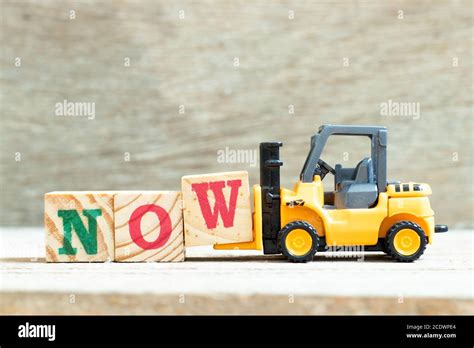 Toy Forklift Hold Letter Block W To Complete Word Now On Wood