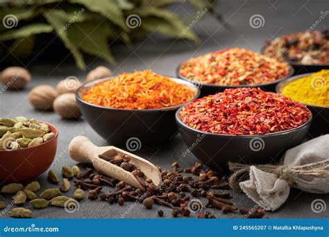 Various Aromatic Indian Spices And Herbs On The White Kitchen Table