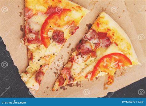 Pizza With Sausage Ham Tomato And Cheese Decorated With Basil And