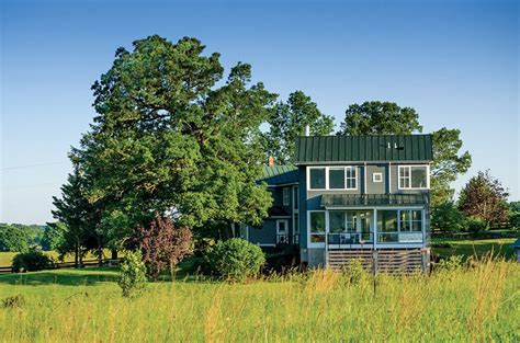 A Rural Mountain House Is Sited Along An Old Logging Road In The Woods