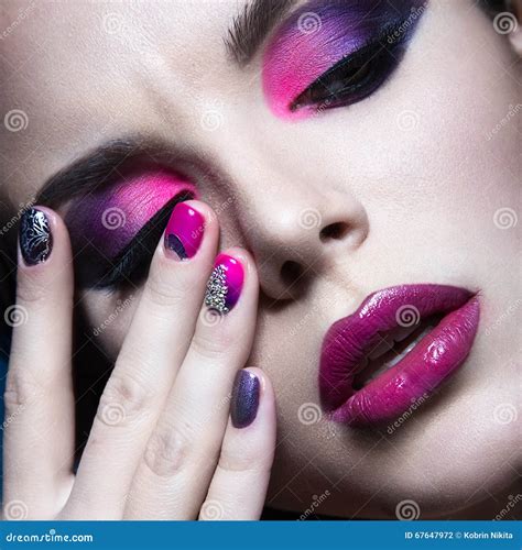 Beautiful Girl With Bright Creative Fashion Makeup And Colorful Nail