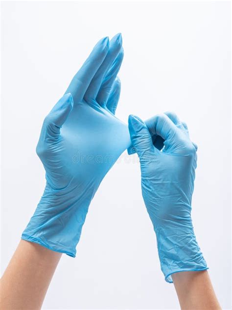 Female Hands In Blue Medical Gloves Stretching Of Durable Nitrile