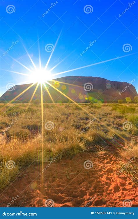 Sunrise behind Uluru editorial photo. Image of landscape - 159689141