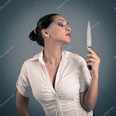 Sexy Brunette Woman Holding A Knife Against Dark Background — Stock