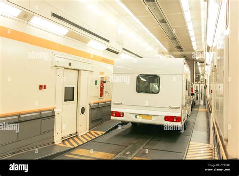 A car and trailer caravan inside a train carriage of a Eurotunnel Le ...