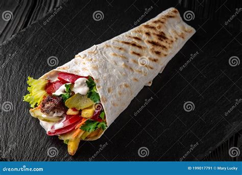 A Delicious Doner Donair Kebab Wrap With Meat Lettuce Tomato Red