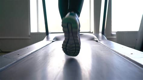 Woman running on treadmill in gym, slow motion 22022852 Stock Video at
