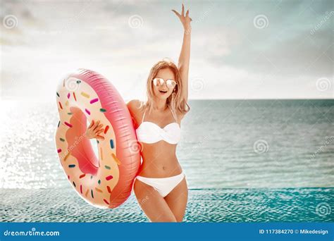 Summer Vacation Enjoying Suntan Woman In White Bikini With Donut