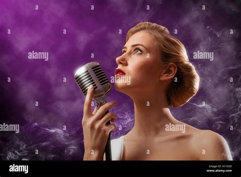 Beautiful Blonde Woman Singer With A Microphone Stock Photo Alamy