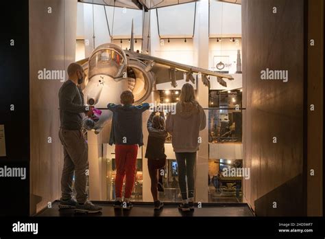 Family looking at exhibits at the Imperial War Museum London, england ...