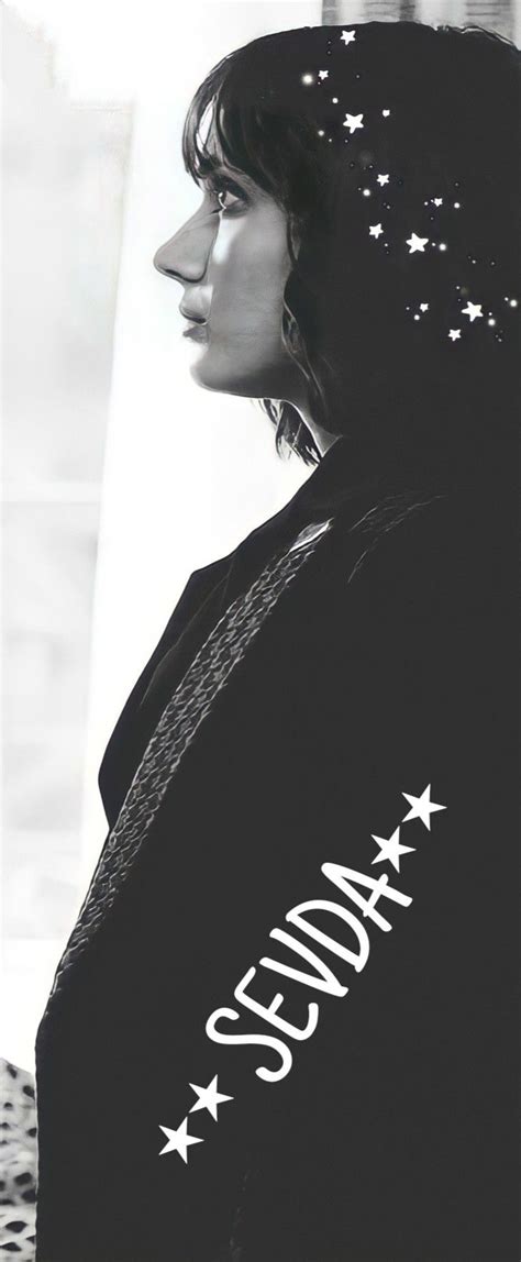 A Black And White Photo Of A Woman With Stars On Her Shirt