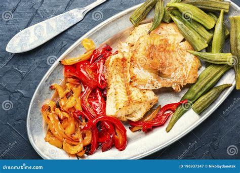 Baked fish with vegetables stock image. Image of close - 196937347