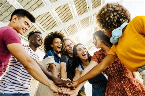 Multiracial happy friends with hands in stack. Multi-ethnic diverse ...