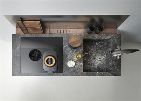 an overhead view of a kitchen sink and counter top with utensils on it