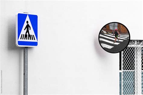 Crosswalk Signal And Pedestrian Crossing In Mirror By Stocksy