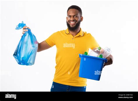 Black Man Holding Garbage Bag And Box Over White Background Stock Photo