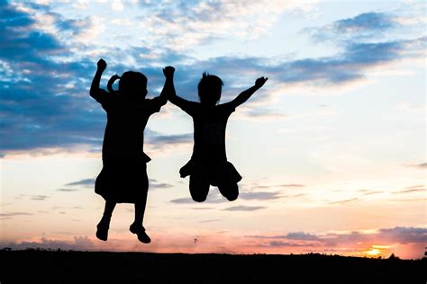 Sunset silhouette of children playing 1977764 Stock Photo at Vecteezy