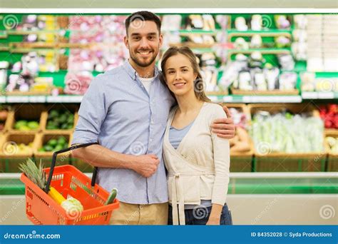 Happy Couple With Food Basket At Grocery Store Stock Photo Image Of