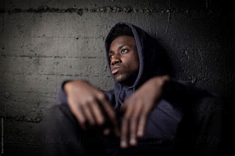 Sad Black Man In Front Of Grunge Wall Stocksy United