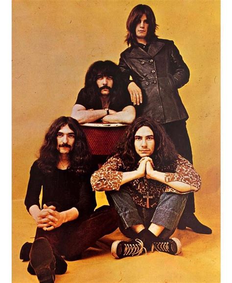 an old photo of three men with long hair and beards sitting on the ground