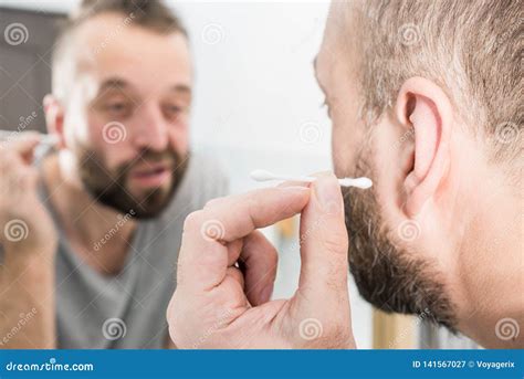 Man Removing Wax From Ear Using Q Tip Stock Image Image Of Health