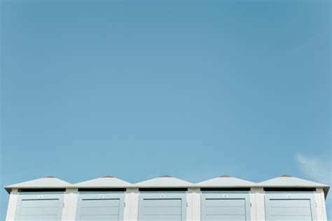 Premium Photo Low Angle View Of Beach Huts Against Clear Blue Sky