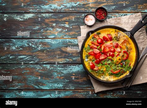 Healthy Frittata In Cast Iron Pan With Fried Beaten Eggs And Seasonal