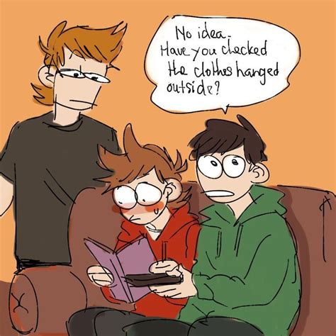 Three People Are Sitting On A Couch And One Is Looking At A Book While