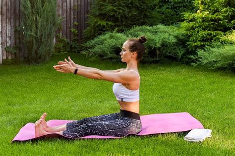 Premium Photo The Girl Is Engaged In Yoga Near The House She Stretches Her Back And Monitors