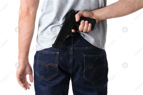 Man Holding Gun Behind His Back On White Background Closeup Stock