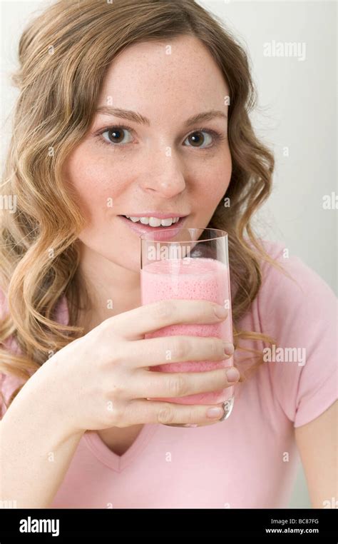 Woman Drinking Strawberry Shake Stock Photo Alamy