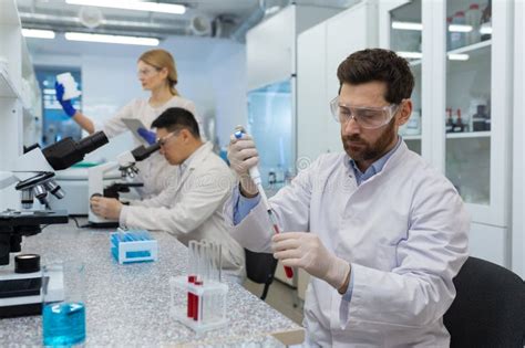 Mature Serious And Concentrated Man Works Inside The Laboratory