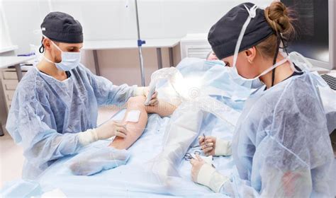 Doctor And An Assistant In Operating Room For Surgical Clinic Stock