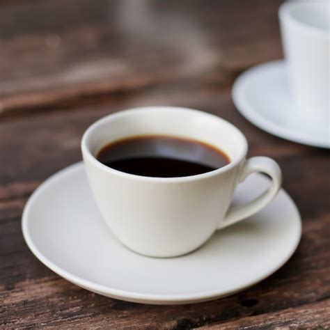 Premium Photo | Coffee cup on a wooden table