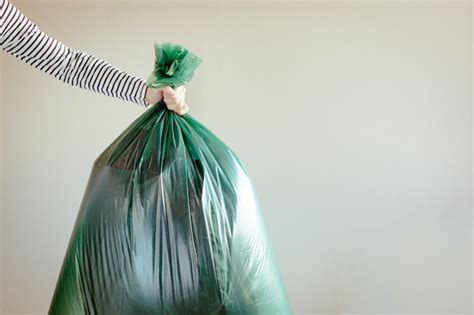 Premium Photo Man Holding Garbage Bag