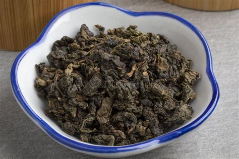 Bowl With Dried Chinese Oolong Se Chung Tea Leaves Close Up Stock Photo