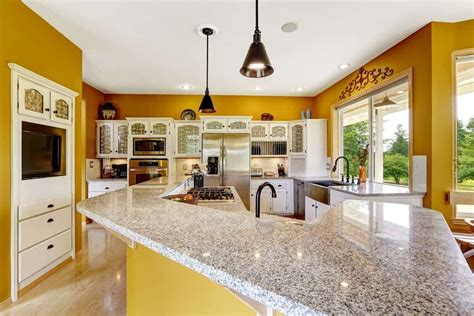 This Kitchen Showcases Stainless Steel Appliances And White Cabinetry