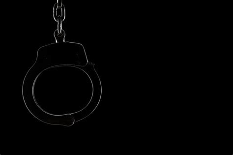 Premium Photo Close Up Of Handcuff Against Black Background