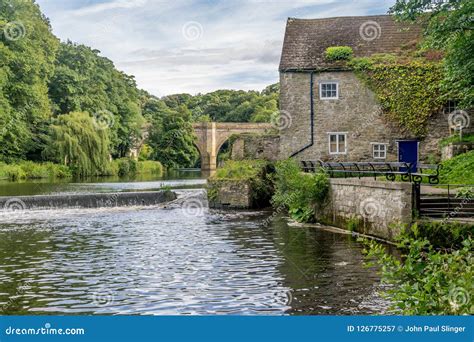 A Cottage Next To River With A Stone Bridge Stock Image Image Of