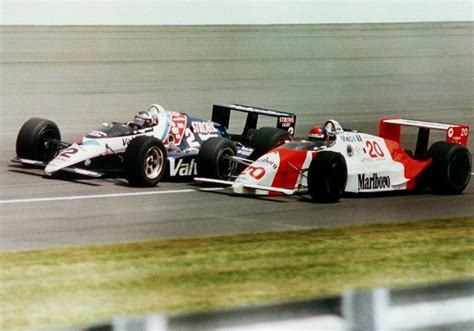 Two Racing Cars On A Race Track During The Day