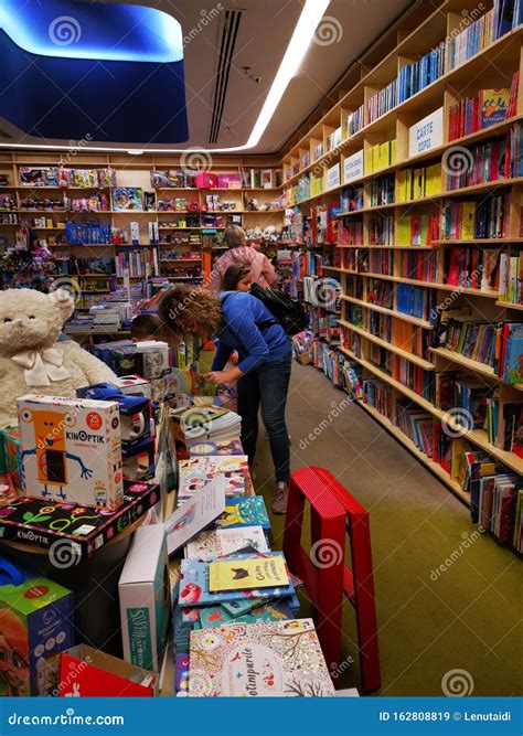 Woman Looking Books For Children At Bookstore Carturesti Editorial