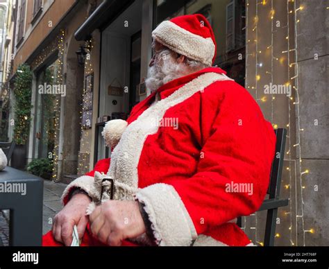 Santa Claus Sitting On A Bench In A Deserted City Due To Covid Stock