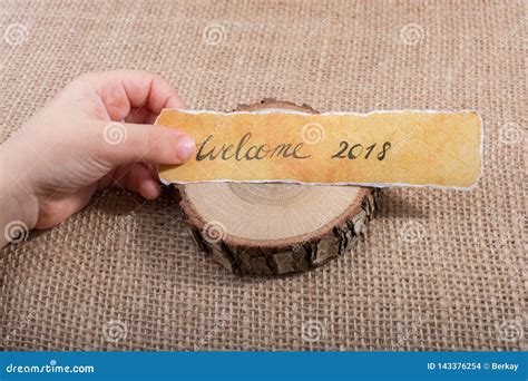 Welcome 2018 Wording Written On A Yellow Torn Paper Stock Photo Image